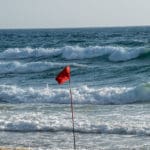 דגל אדום מונף בחוף הים של חיפה בשקיעה (צילום: ירון כרמי)