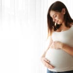 portrait-happy-pregnant-woman-touching-her-belly