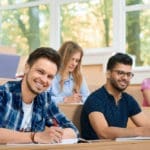 frontview-studuing-during-lesson-students-looking-camera