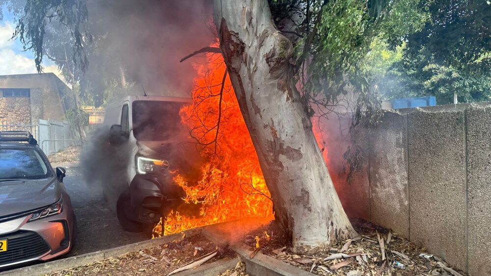 חיפה: רכב מסחרי בער כולו וגרם לנזק לרכב נוסף ולמתקן איסוף קרטונים (צילום: כבאות והצלה)
