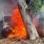 חיפה: רכב מסחרי בער כולו וגרם לנזק לרכב נוסף ולמתקן איסוף קרטונים (צילום: כבאות והצלה)