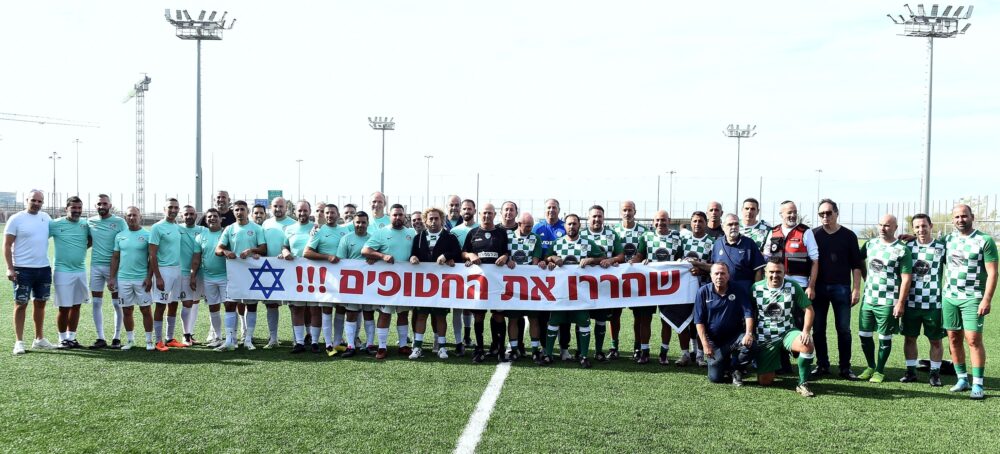 וותיקי מכבי מכבי חיפה וותיקי מכבי שלומי עם השלט "שחררו את החטופים !!!"