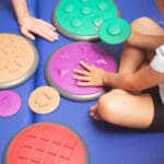 Child touching sensory integration equipment