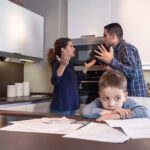 Sad child suffering and parents having discussion