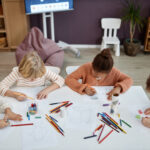 Top view at multiethnic group of children doing arts and crafts