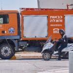 כבאי, כבאית, כבאות, כיבוי אש, שריפה, להבות, עשן, ציוד מגן, קסדה, מדים, צינור מים, מים, חום, סכנה, חירום, פעולה, הצלה, משאבת מים, זירה, פיח, צוות כיבוי, רכב כיבוי, חילוץ, חילוץ מגובה, חילוץ מרכב, חילוץ ממים, ציוד חילוץ, נשיאת פצועים, סנפלינג, מערכות נשימה, חדירה מבוקרת, חילוץ מיוחד, כבאות והצלה, מפגע, אשכול אש, חומרים מסוכנים, פריצה, סולם אש, זרנוק, הידרנט, מערכת גילוי אש, מערכת כיבוי אוטומטית, מניעת דליקות, בטיחות אש, חקירת שריפות, שיקום נזקי שריפה, מתנדב, תרגיל כיבוי, כוננות, אירוע רב נפגעים, אחראי בטיחות, הדרכה, רישוי עסקים, תקנות כיבוי אש, חדר בקרה, קצף כיבוי, שמיכת כיבוי, מטף כיבוי, עזרה ראשונה, פינוי, נקודת כינוס, קריסת מבנים, אש, כבאית, סולם, צוות, אורות, צופר, קורבן, פצוע, ריח, סירנה, קריסה, בטיחות
