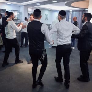 הילולת פורים, חג פורים, ישיבה, חגיגה דתית, שמחת תורה, קהילה יהודית, חיפה, אירוע דתי, מסורת יהודית, תלמידי ישיבה, קריאת מגילה, תחפושות, סעודת מצווה, אחדות, חוסן אזרחי, שגרה בצל מלחמה, חיים בצל מלחמה, רוח יהודית, תרבות יהודית, חגיגות למרות המלחמה, אמונה, התכנסות קהילתית, חיי דת בישראל