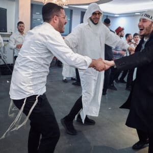 הילולת פורים, חג פורים, ישיבה, חגיגה דתית, שמחת תורה, קהילה יהודית, חיפה, אירוע דתי, מסורת יהודית, תלמידי ישיבה, קריאת מגילה, תחפושות, סעודת מצווה, אחדות, חוסן אזרחי, שגרה בצל מלחמה, חיים בצל מלחמה, רוח יהודית, תרבות יהודית, חגיגות למרות המלחמה, אמונה, התכנסות קהילתית, חיי דת בישראל