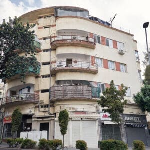 אדריכלות עירונית, מסורת, ארכיטקטורה, הסגנון הבינלאומי, באוהאוס, בית לוינסקי ינוביץ, רחוב הרצל, רחוב ארלוזורוב, חזית מבנה, קווים מעוגלים, מרפסות מעוגלות, קרניזים, חלונות סרט, פרגולה, קומת גג, חיפוי טיח, חדר מדרגות, מסחר, חנויות, נוף עירוני, מבנה לשימור, הדר הכרמל
